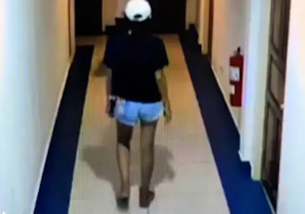 CCTV showed the woman in a black shirt and white cap walking along the hotel corridor on December 18