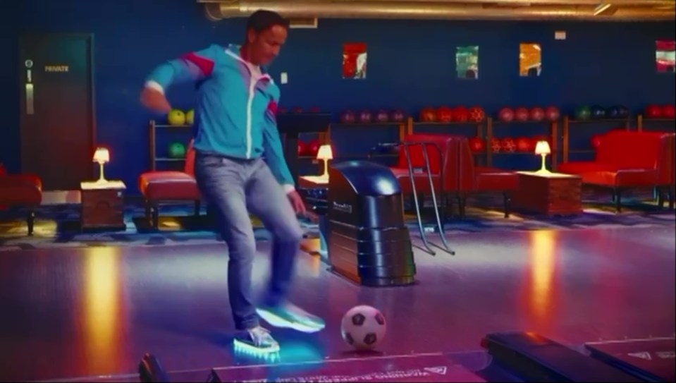 Dennis plays football in the video