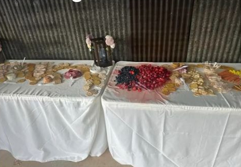 Wedding grazing table with fruit, crackers, and cheese.