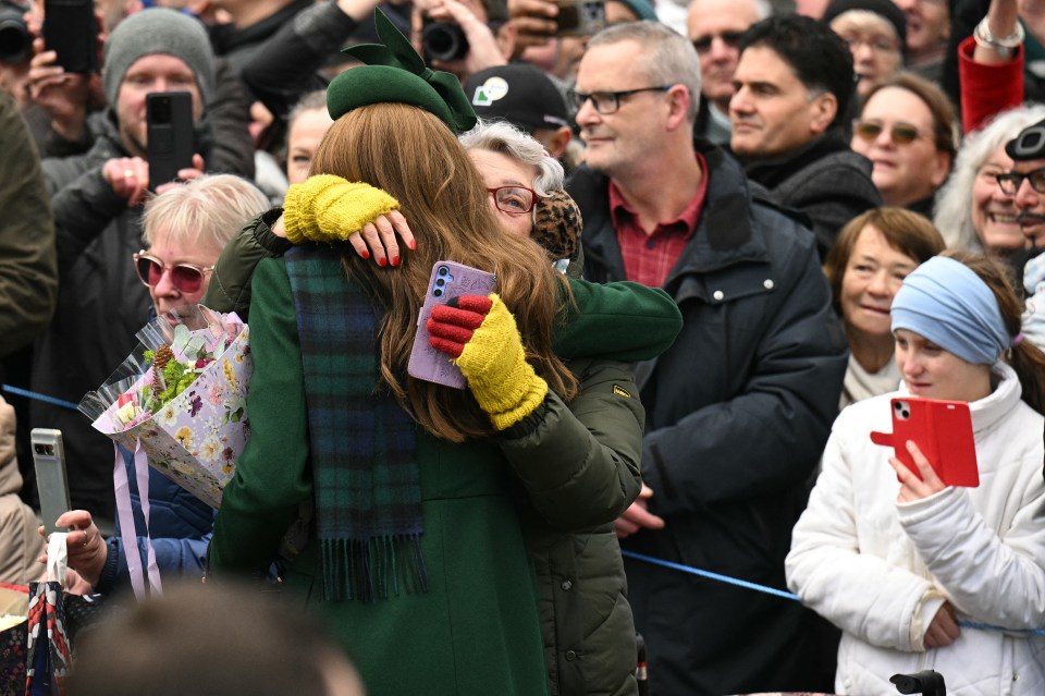 Princess Catherine hugging a well-wisher after a Christmas Day service.