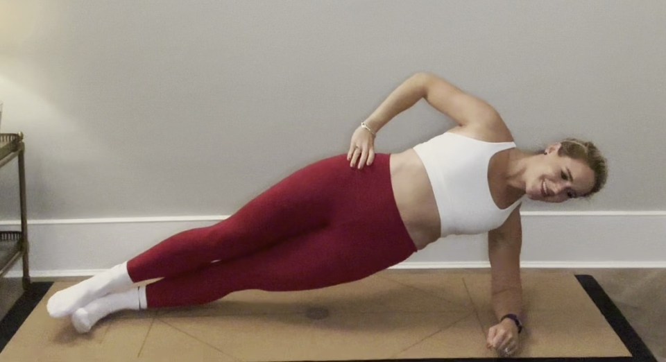 Woman performing a side plank exercise.