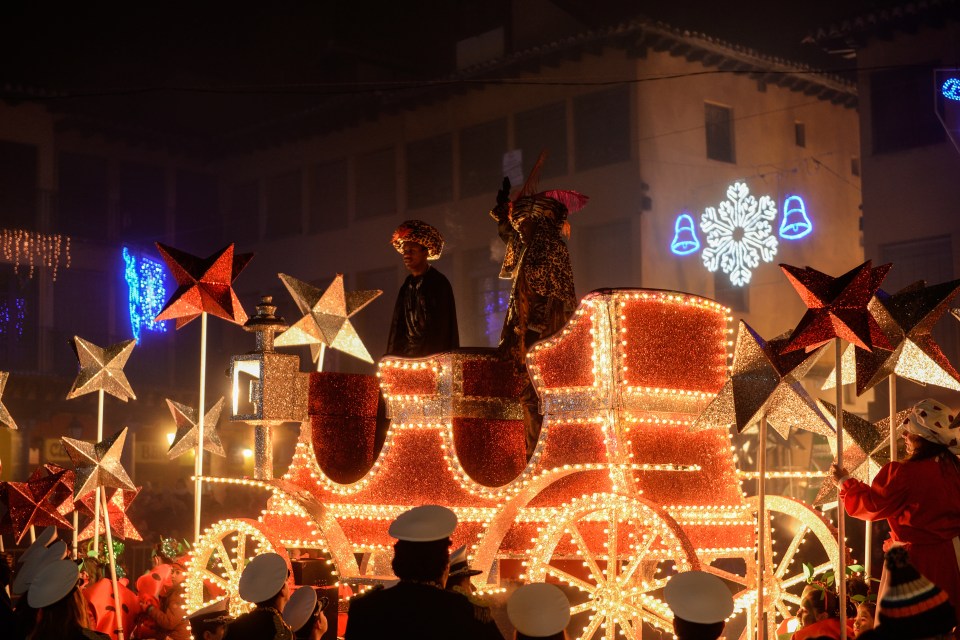 Crowds line the route to see the kings’ parade, which has a carnival atmosphere