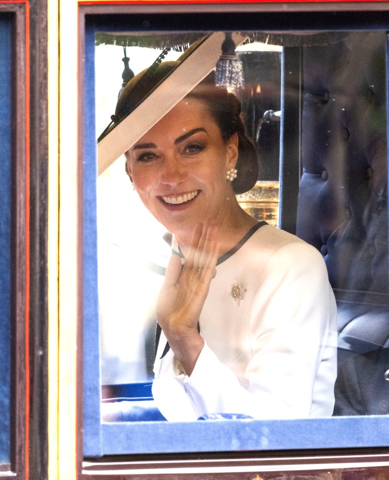 Catherine, Princess of Wales, waving from a carriage.