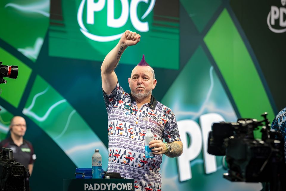 Peter Wright celebrates winning his fourth-round darts match.