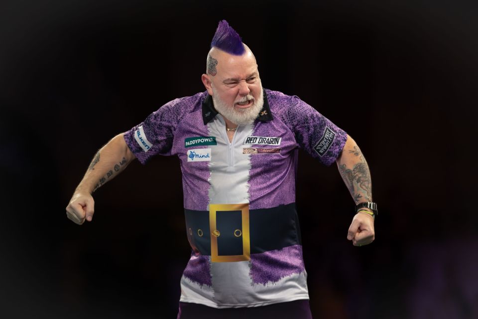 Peter Wright celebrates winning his second-round darts match.