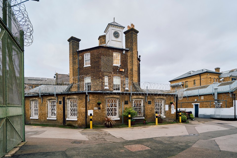 Exterior view of a prison building with a clock tower.