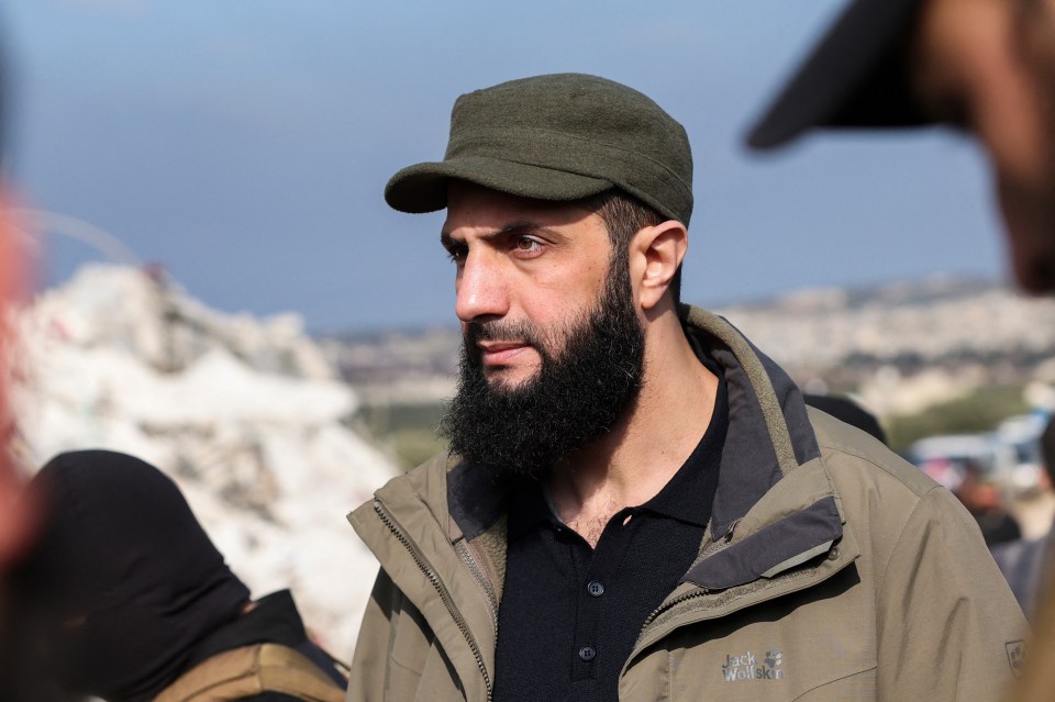 Al-Jolani checks the damage following an earthquake in Idlib province in 2013