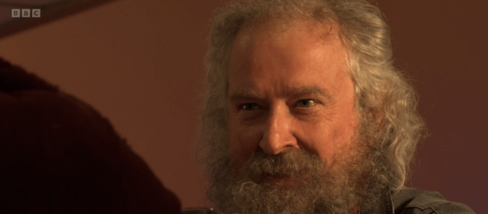 Close-up of a man with long gray hair and beard.