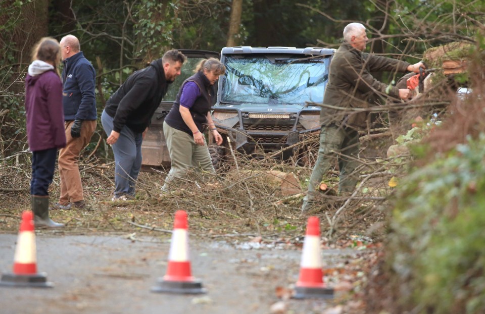 A team of locals clear the road of fallen trees at Kingston St Mary on the main route from Taunton to Nether Stowey