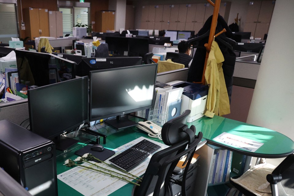 The empty desks of five co-workers killed in the crash