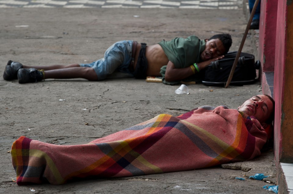 Two drug addicts sleeping on a sidewalk in Sao Paulo, Brazil.