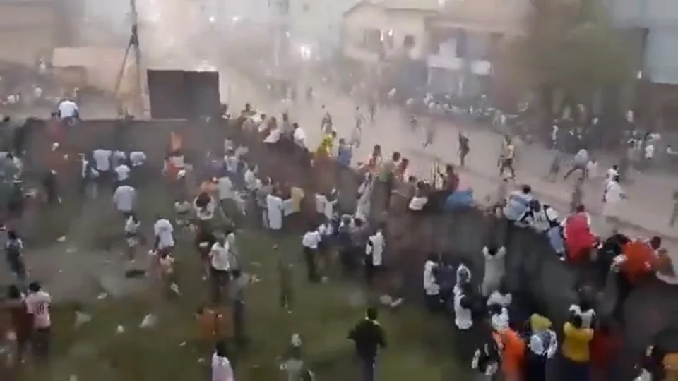 Desperate fans try to escape the stadium following the deadly stampede