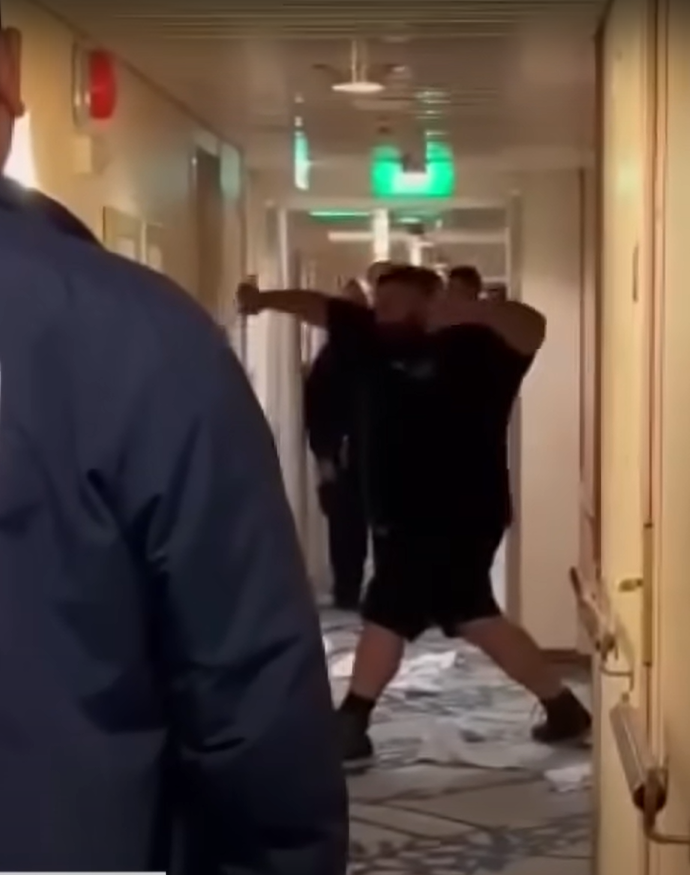 A passenger being restrained on a cruise ship after a rampage.