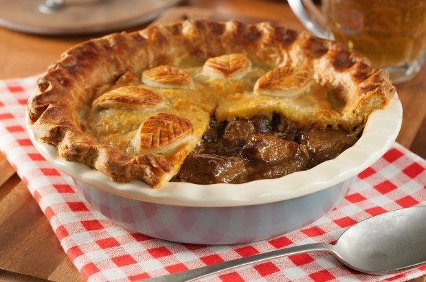 Steak and ale pie in a blue dish.