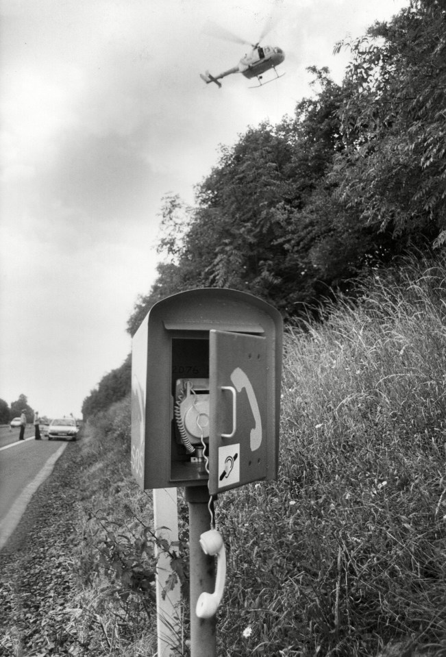 The abandoned SOS telephone with its handset left off its hook on the hard shoulder of the M50