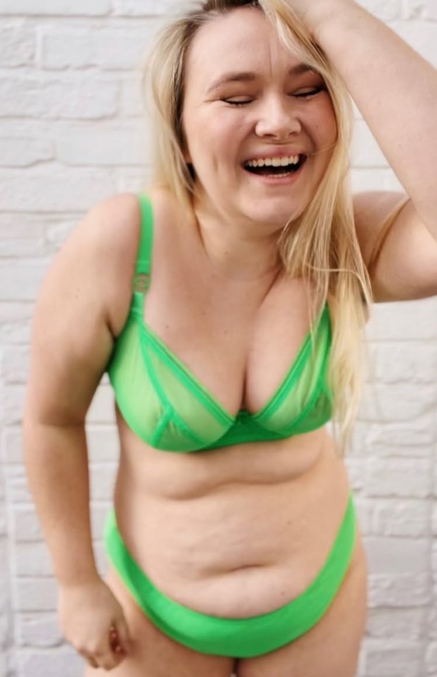 Woman in green lingerie laughing.