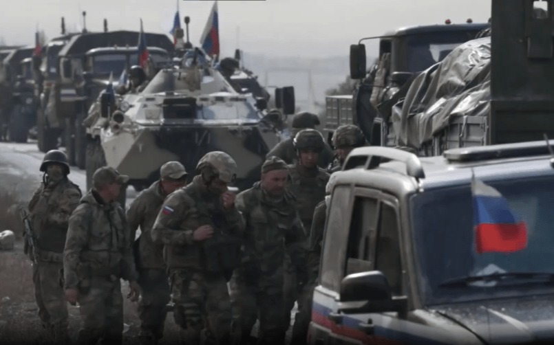 Soldiers and military vehicles in a convoy.