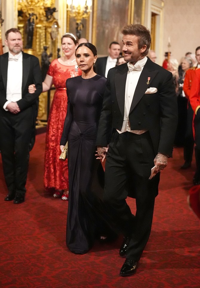 David and Victoria Beckham make their way along the East Gallery to attend the state banquet