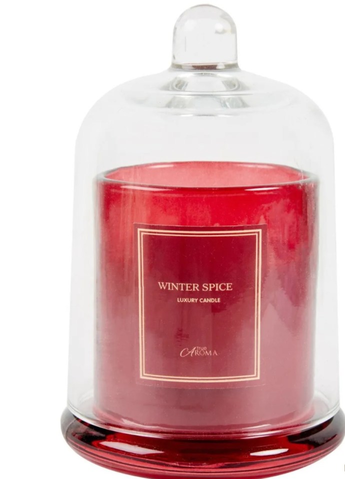 Red Winter Spice luxury candle under a glass dome.