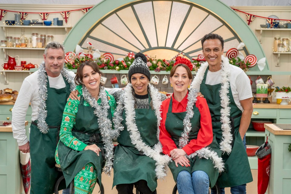 Five celebrities in festive attire posing for a Christmas photo.