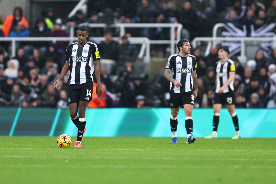 Alexander Isak of Newcastle United looking dejected on the pitch.