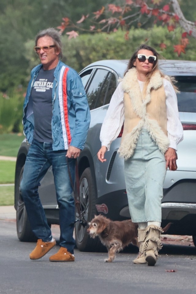 Hart Bochner and a woman walking a small dog.