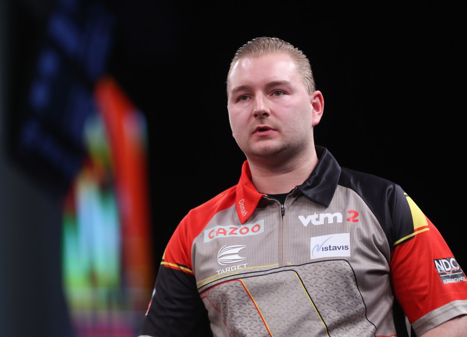 Dimitri Van den Bergh at a darts match.