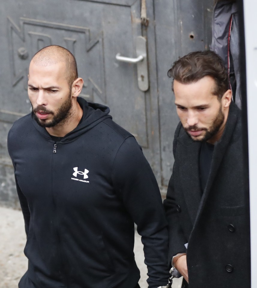 Andrew Tate and his brother Tristan Tate, handcuffed, leaving a court hearing.