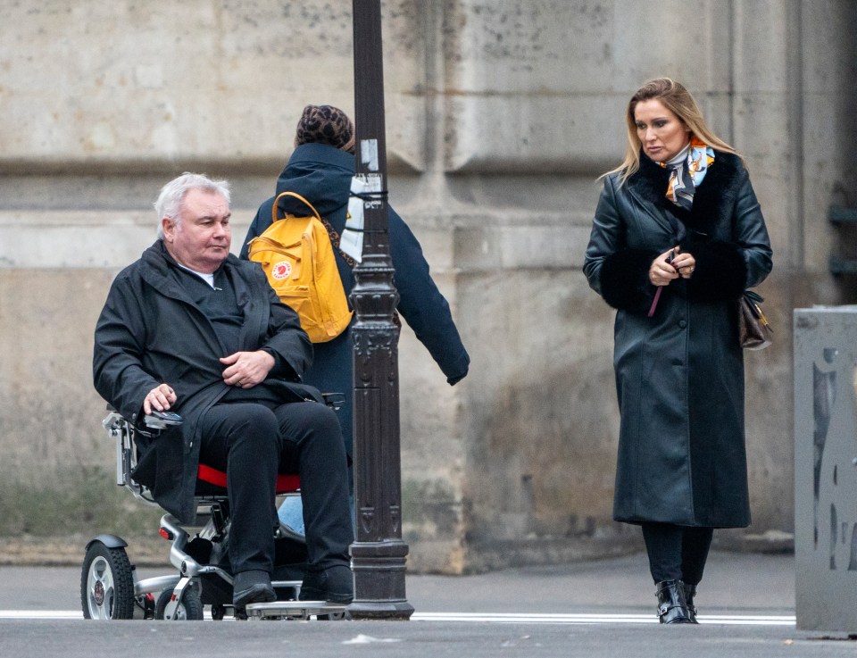 Eamonn Holmes in a wheelchair and Katie Alexander arriving at the Louvre in Paris.