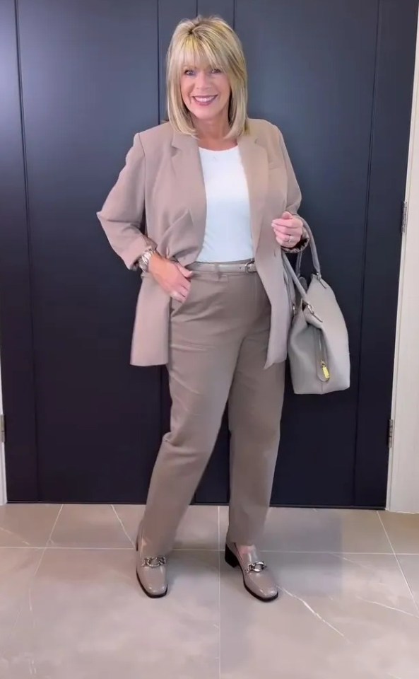 Ruth Langsford in a taupe pantsuit and loafers.