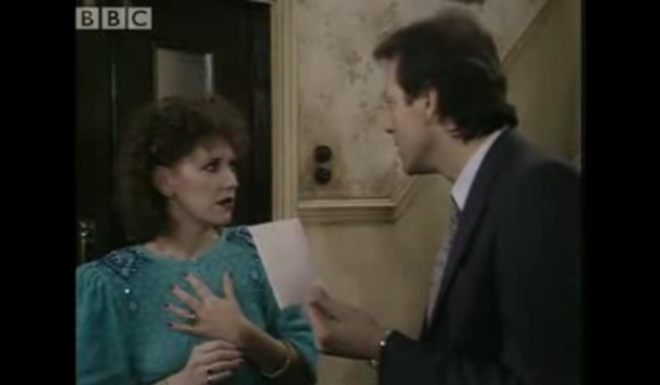 Screenshot from the 1986 EastEnders Christmas episode showing Den and Angie Watts.