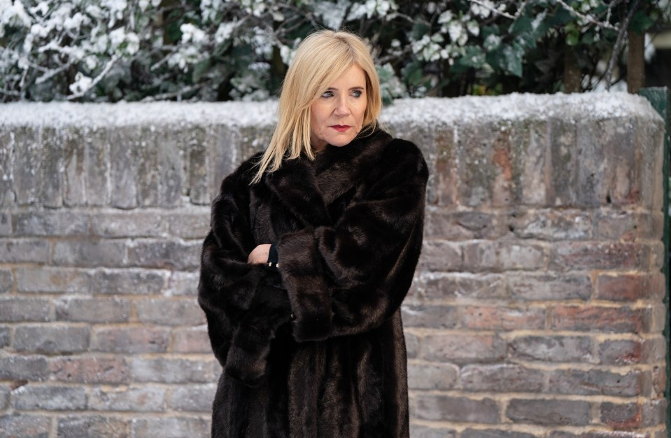 Michelle Collins as Cindy Beale in a brown fur coat.