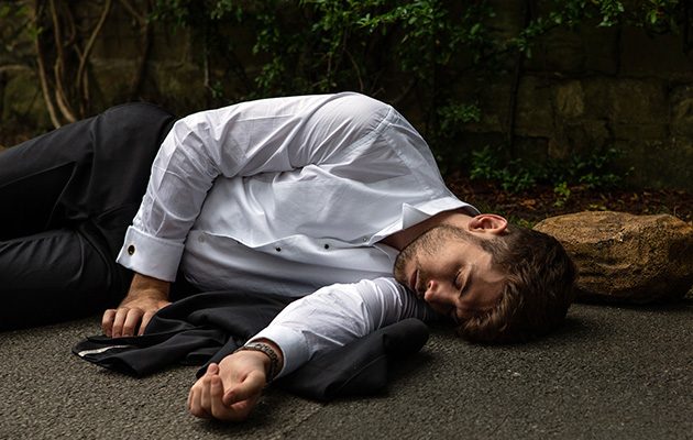 Man lying unconscious on the ground.