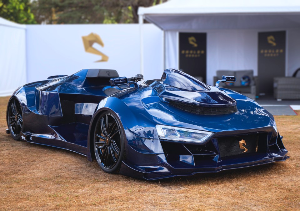 A blue Engler Desat sports car on display at Salon Prive.