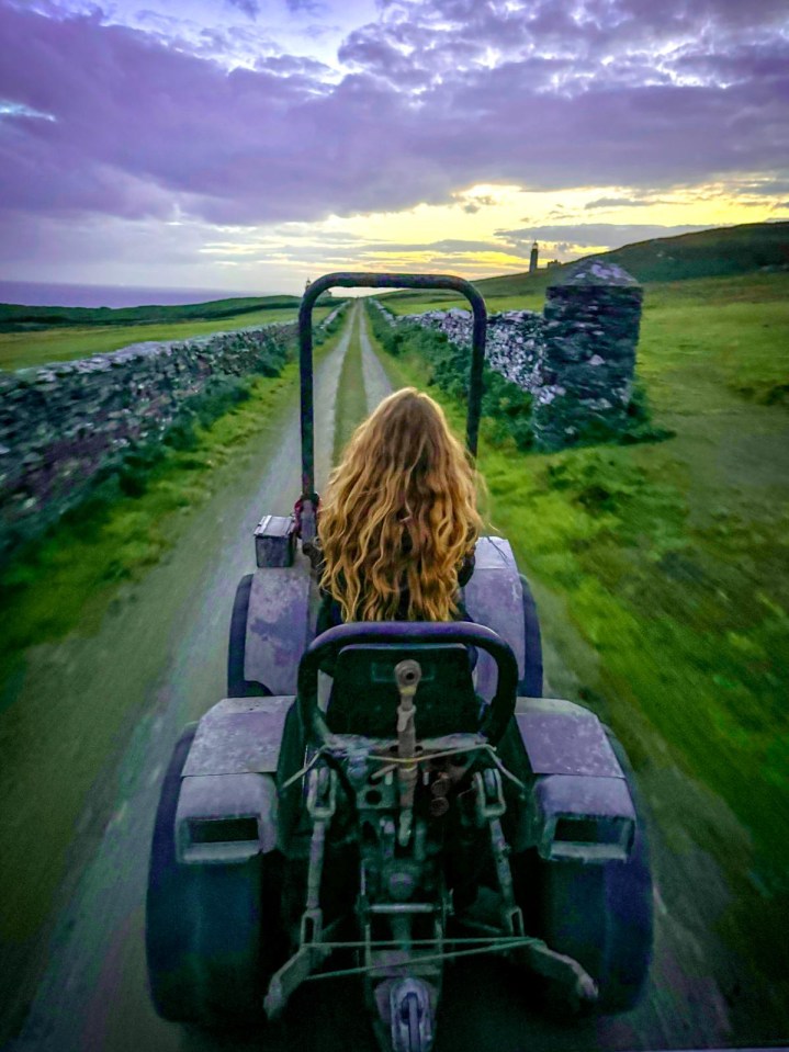 Woman driving a tractor on a remote island.