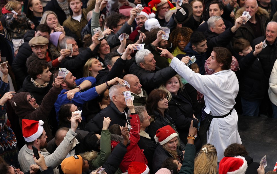 A Christmas Eve meat auction at Smithfield Market in London, with people holding up cash to bid.