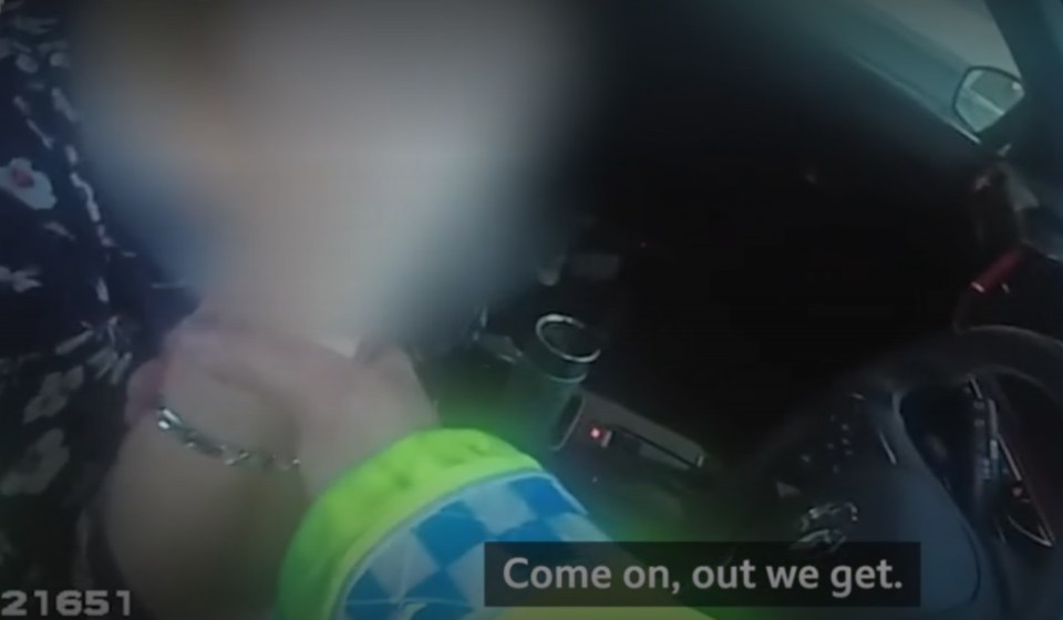 In video footage released by the police, an officer is seen trying to get a drunk driver out of her car