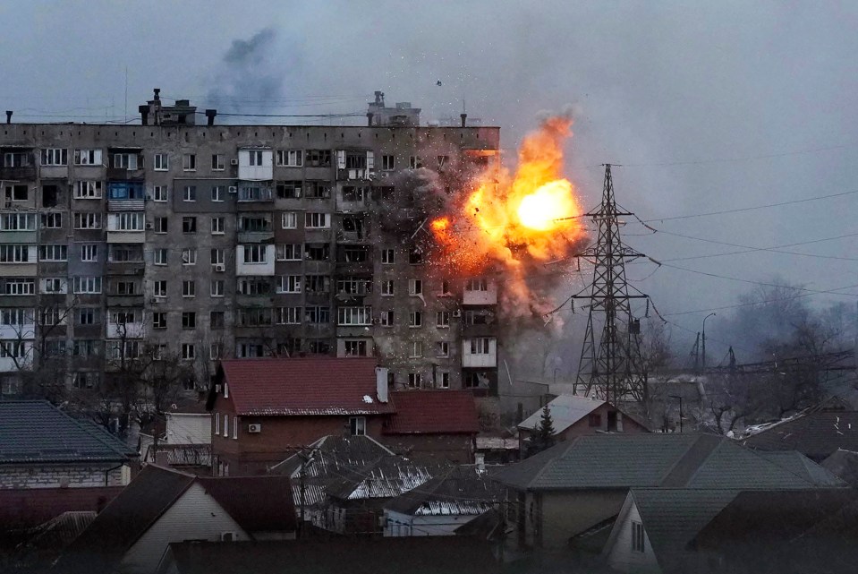 An explosion is seen in an apartment building after Russian’s army tank fires in Mariupol, Ukraine