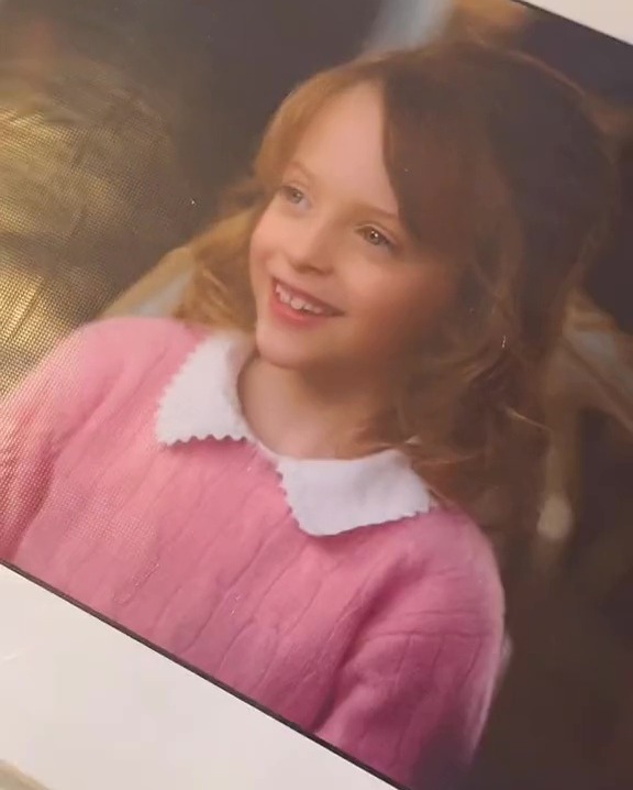 Photo of a young girl in a pink sweater, from a deleted scene in *The Holiday*.