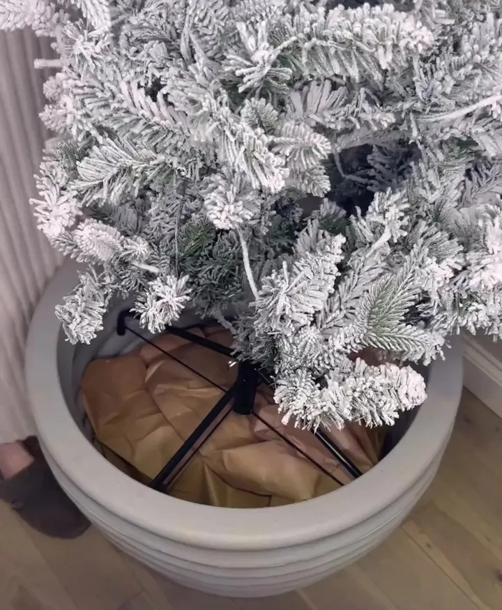 A mum shared how she puts her tree in a stuffed plant pot to give it more height