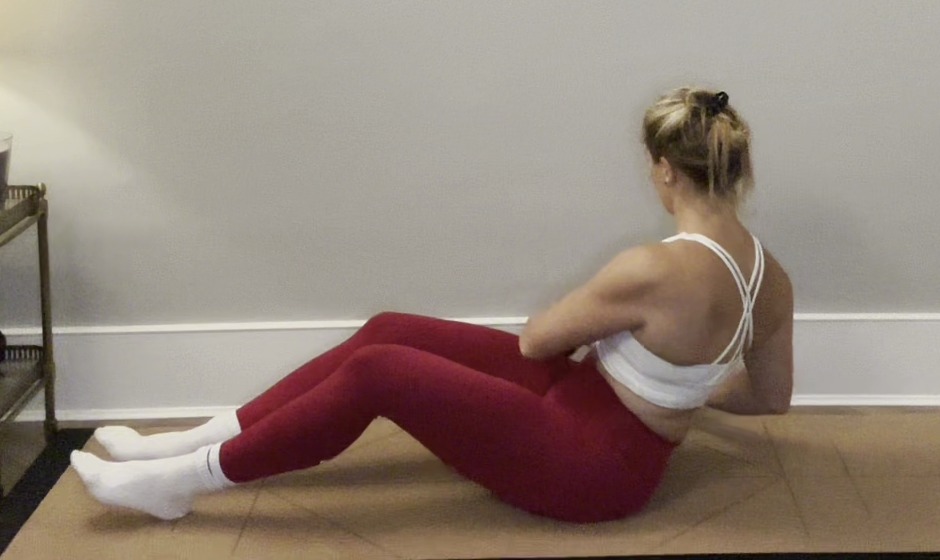 Woman performing an exercise to target love handles.