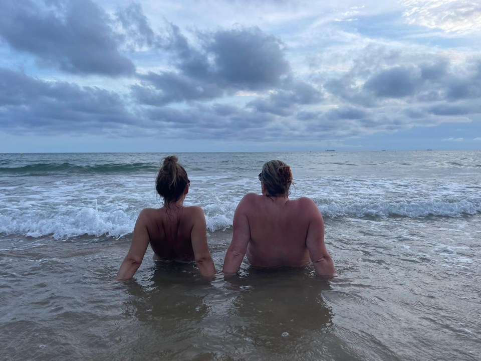 Estelle, left, naked in the sea at Brighton