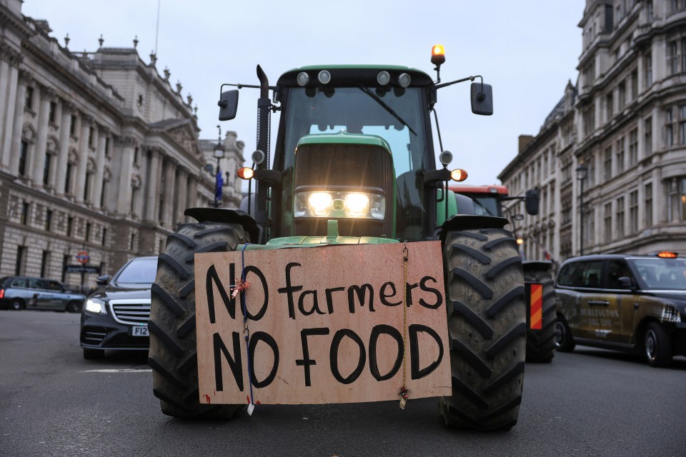 A tractor adorned with a sign saying: 'No farmers, no food'