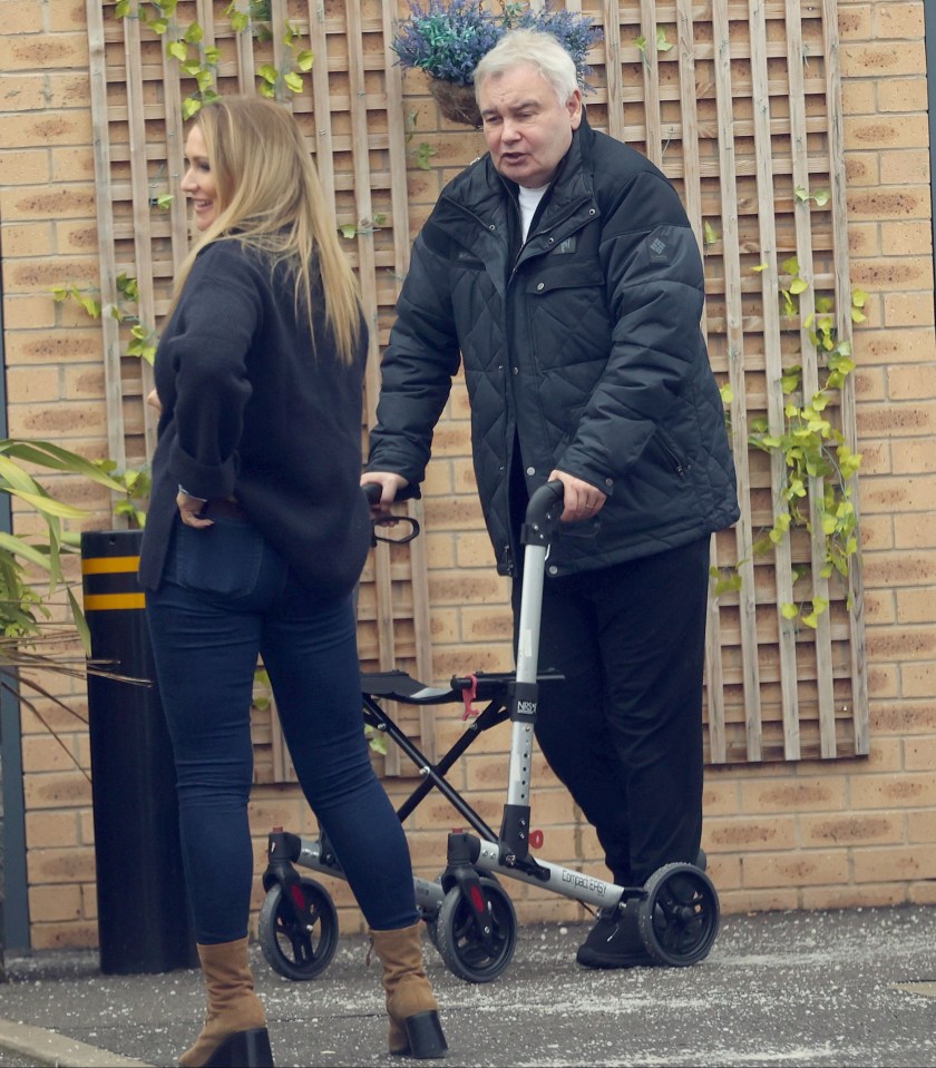 Holmes walking with a frame