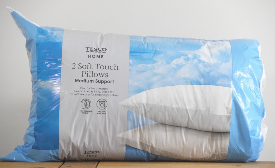 Two Tesco Home medium support pillows in plastic packaging.