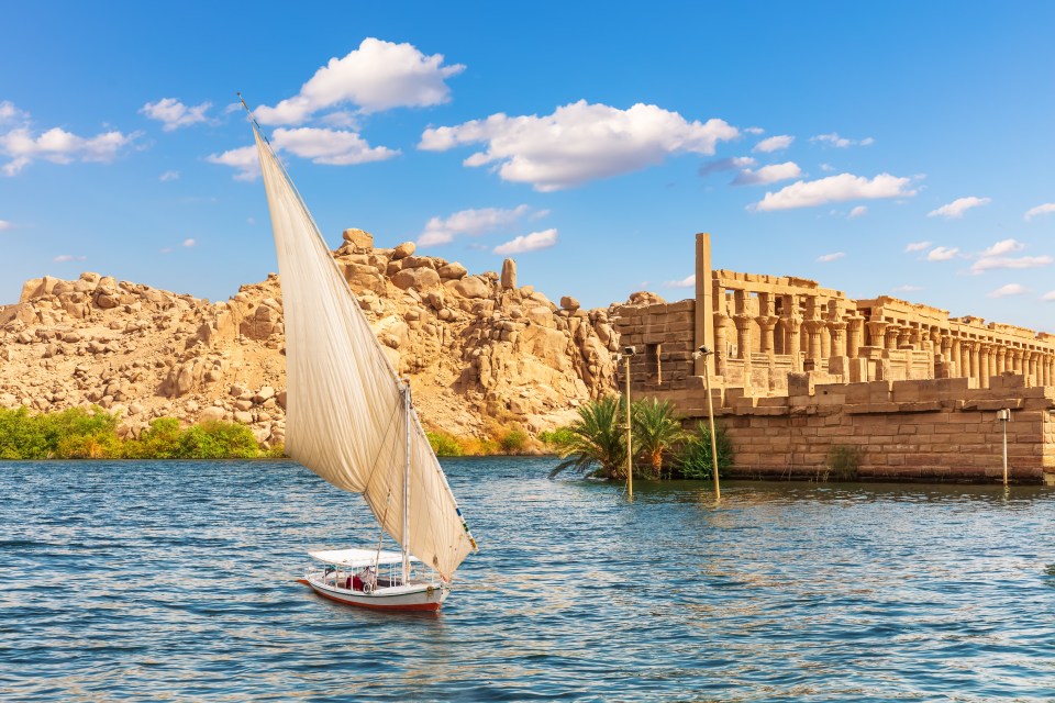 Felucca sailing past the Temple of Philae on Agilikia Island.