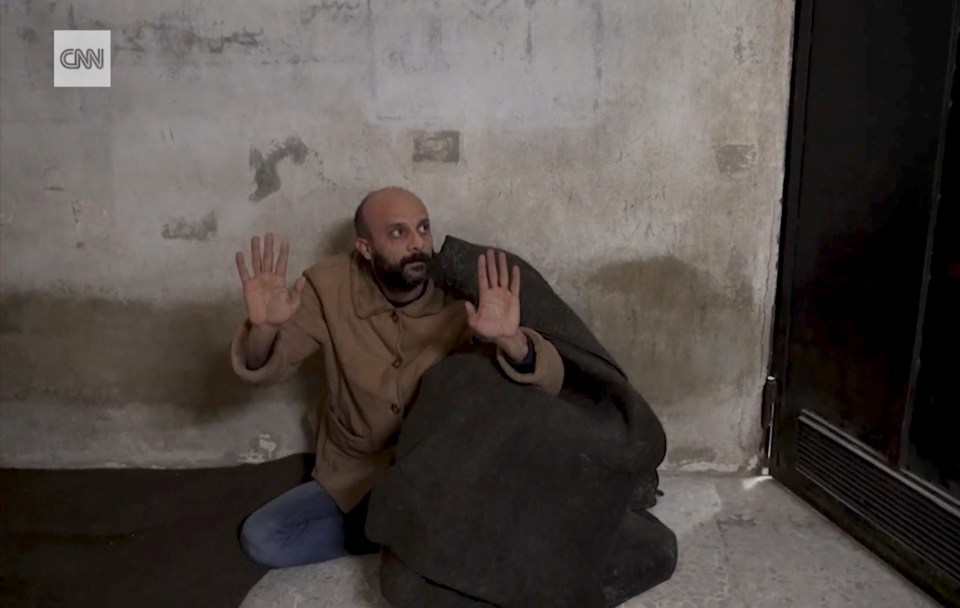 The TV crew found the Syrian prisoner hiding under a blanket