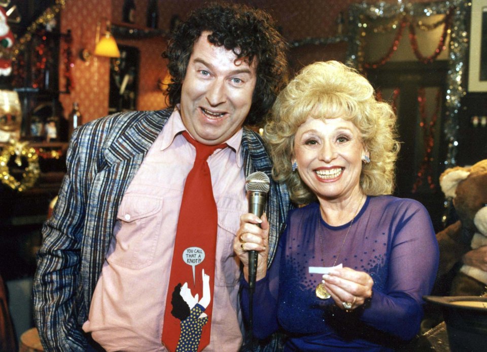 Barbara Windsor and Paul Bradley playing forfeits on the set of *EastEnders*.