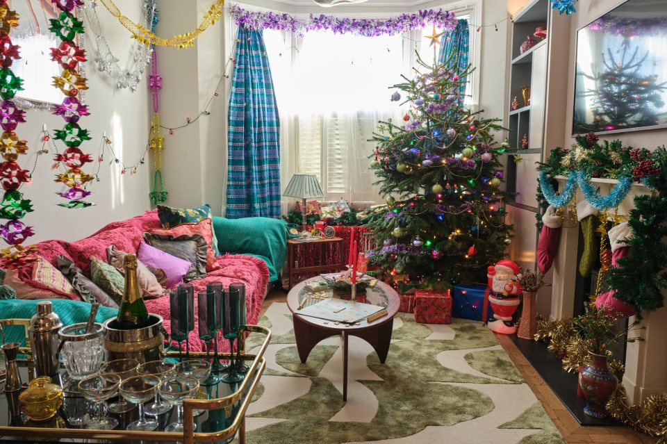 The accommodation is decked out with shimmering tinsel, vintage baubles, and iconic 80s toys scattered under the tree