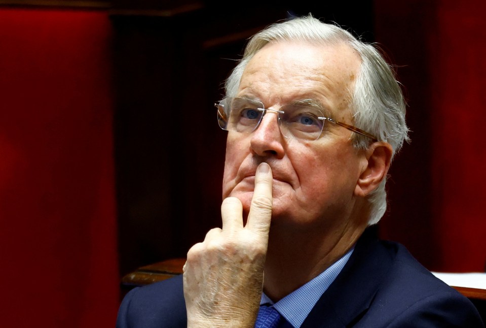 French Prime Minister Michel Barnier reacts after the result of the no-confidence vote